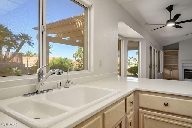 9524 Quail Ridge Dr, Las Vegas, NV 89134 - kitchen featuring a sink, a ceiling fan, lofted ceiling, light countertops, and light brown cabinetry