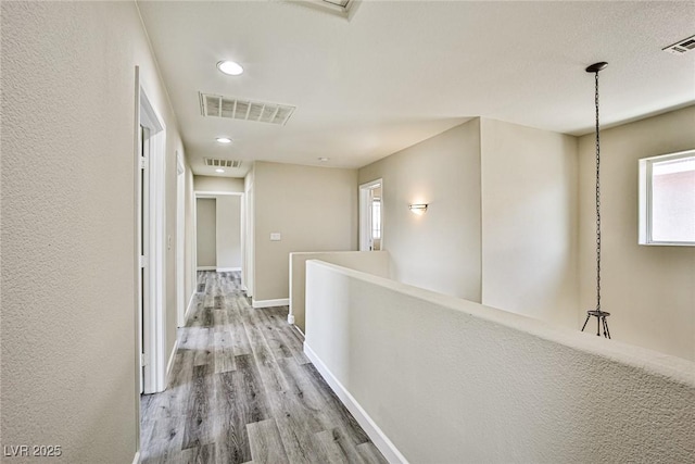 7083 Somera Way, Las Vegas, NV 89113 - corridor with wood finished floors, recessed lighting, baseboards, and an upstairs landing