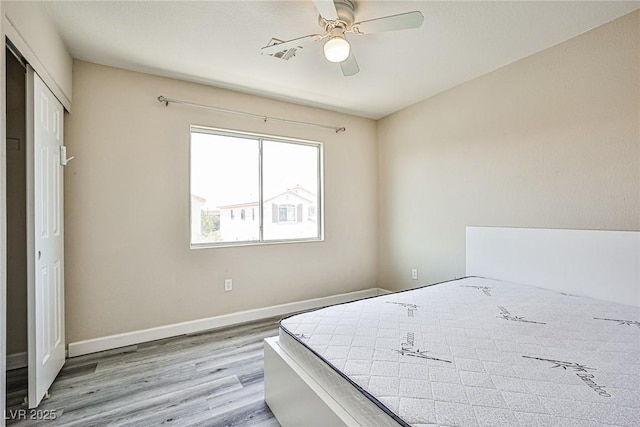 7083 Somera Way, Las Vegas, NV 89113 - bedroom with wood finished floors, baseboards, a ceiling fan, and a closet