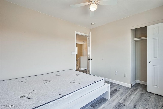 7083 Somera Way, Las Vegas, NV 89113 - unfurnished bedroom featuring wood finished floors, baseboards, a ceiling fan, and a closet