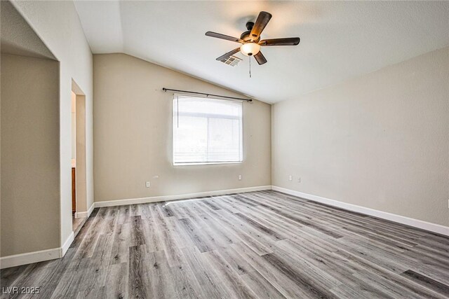 7083 Somera Way, Las Vegas, NV 89113 - spare room featuring lofted ceiling, wood finished floors, a ceiling fan, and baseboards