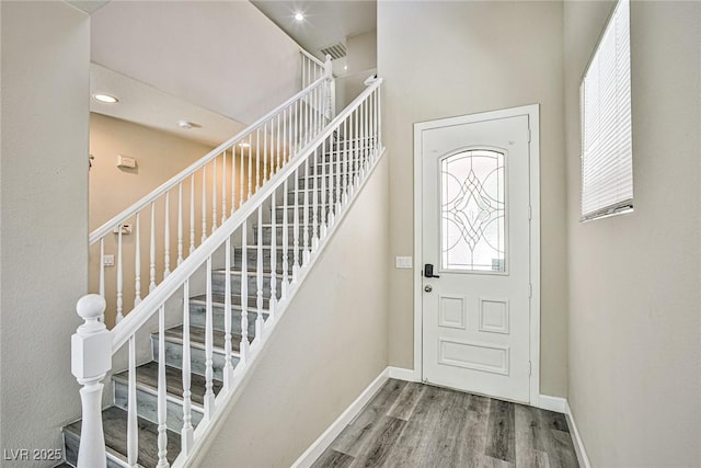 7083 Somera Way, Las Vegas, NV 89113 - entrance foyer with plenty of natural light, wood finished floors, stairway, baseboards, and recessed lighting