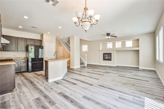 7083 Somera Way, Las Vegas, NV 89113 - kitchen with freestanding refrigerator, a sink, ceiling fan, exhaust hood, and light countertops