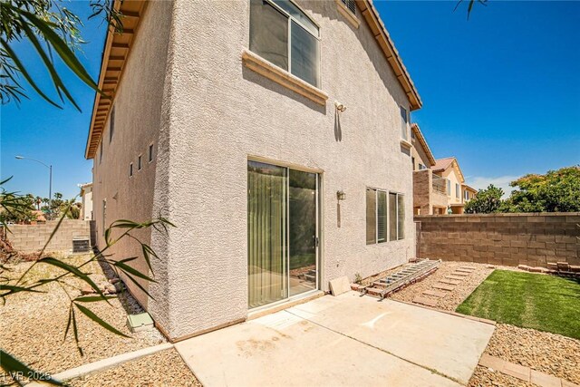 7083 Somera Way, Las Vegas, NV 89113 - rear view of house featuring stucco siding, a patio, and a fenced backyard