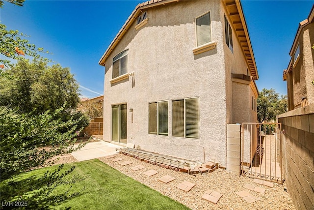 7083 Somera Way, Las Vegas, NV 89113 - rear view of property with stucco siding and a gate