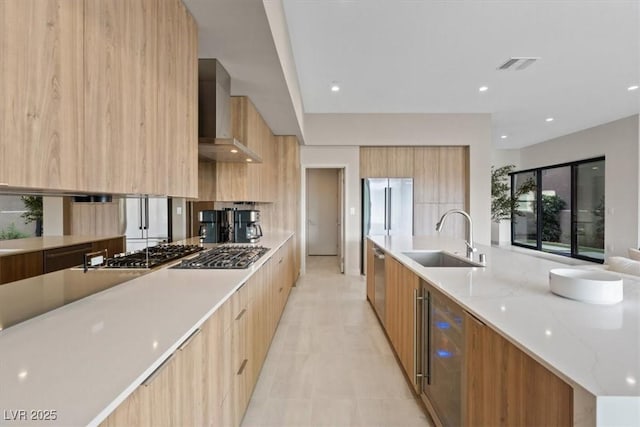40 Heron Harbour Dr, Henderson, NV 89011 - kitchen with modern cabinets, a sink, wall chimney exhaust hood, appliances with stainless steel finishes, and wine cooler