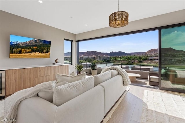 40 Heron Harbour Dr, Henderson, NV 89011 - living area featuring light wood-style floors, a mountain view, wine cooler, and recessed lighting