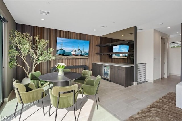 40 Heron Harbour Dr, Henderson, NV 89011 - dining room featuring an accent wall, wood walls, light tile patterned floors, baseboards, and recessed lighting