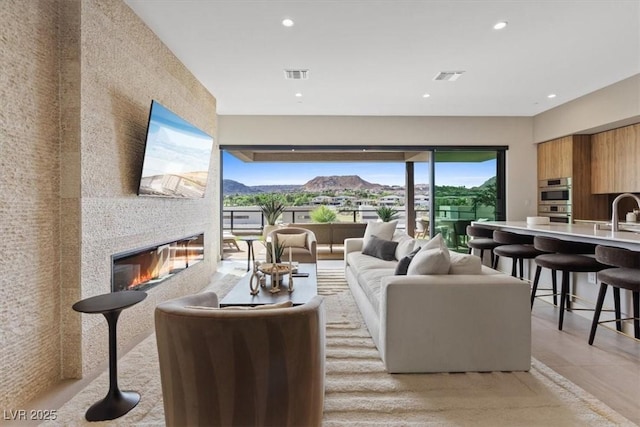 40 Heron Harbour Dr, Henderson, NV 89011 - living room featuring a glass covered fireplace and recessed lighting