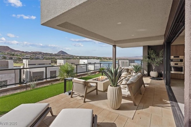 40 Heron Harbour Dr, Henderson, NV 89011 - view of patio / terrace featuring a balcony, a mountain view, and an outdoor fire pit