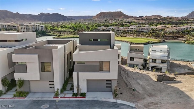 40 Heron Harbour Dr, Henderson, NV 89011 - view of front of home with a garage, a water and mountain view, and stucco siding
