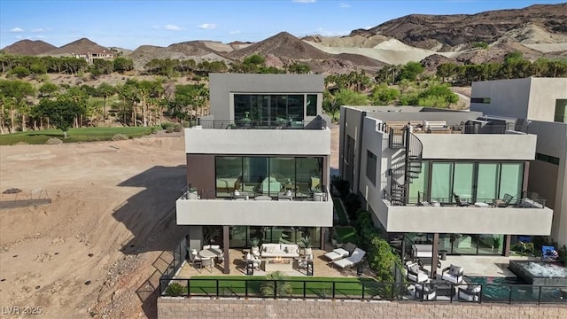 40 Heron Harbour Dr, Henderson, NV 89011 - back of property featuring a balcony, a patio, a fenced backyard, a mountain view, and stucco siding