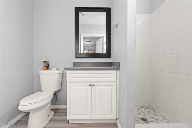 5004 Cannon Blvd, Las Vegas, NV 89108 - bathroom featuring toilet, a shower stall, vanity, baseboards, and wood finished floors