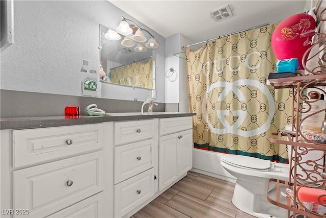 5004 Cannon Blvd, Las Vegas, NV 89108 - full bath with vanity, toilet, wood finished floors, and shower / bathtub combination with curtain