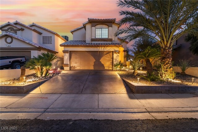 5779 Baffy Cir, Las Vegas, NV 89142 - mediterranean / spanish-style house featuring stucco siding, driveway, a garage, and a tiled roof