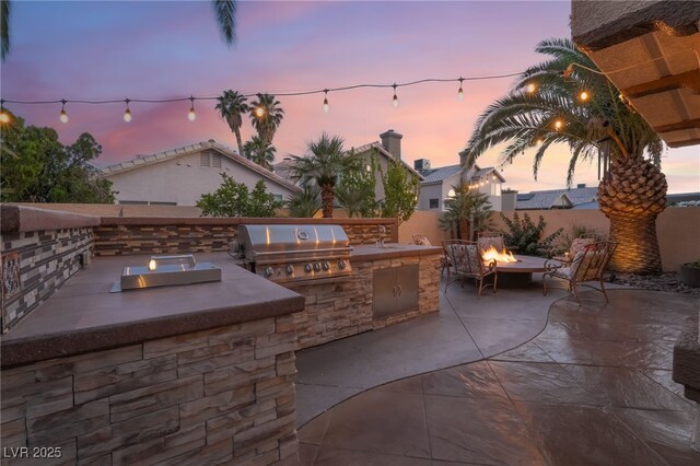 5779 Baffy Cir, Las Vegas, NV 89142 - patio terrace at dusk featuring a fire pit and a patio area