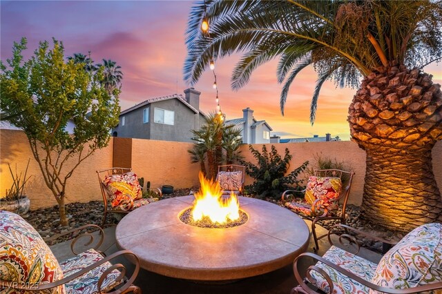 5779 Baffy Cir, Las Vegas, NV 89142 - fenced backyard with a fire pit and a patio area