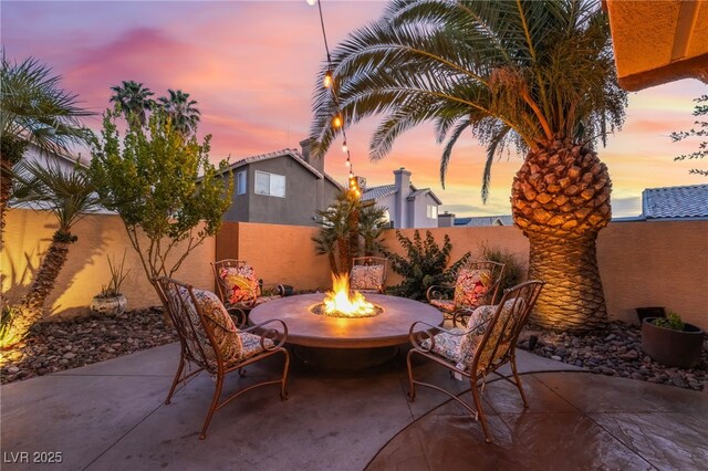 5779 Baffy Cir, Las Vegas, NV 89142 - fenced backyard with a fire pit and a patio area