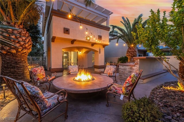 5779 Baffy Cir, Las Vegas, NV 89142 - patio terrace at dusk with a fire pit and a patio area