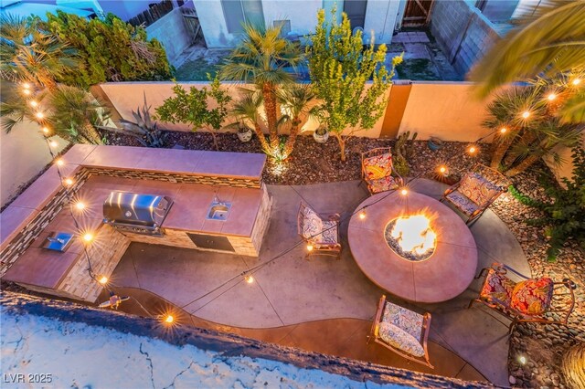 5779 Baffy Cir, Las Vegas, NV 89142 - view of pool with an outdoor fire pit, an outdoor kitchen, a fenced backyard, and a patio