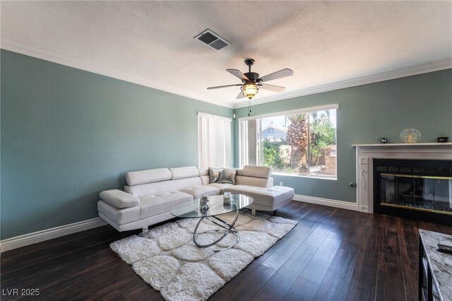 5779 Baffy Cir, Las Vegas, NV 89142 - living room with baseboards, ornamental molding, hardwood / wood-style floors, a glass covered fireplace, and a ceiling fan
