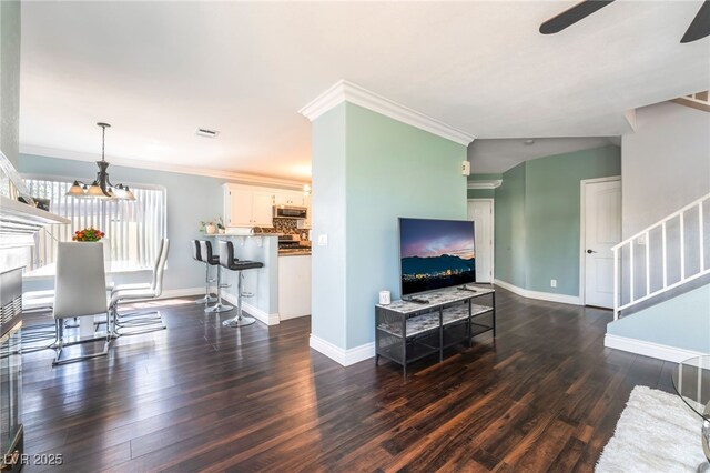 5779 Baffy Cir, Las Vegas, NV 89142 - living room featuring stairway, dark wood-style flooring, a ceiling fan, baseboards, and ornamental molding