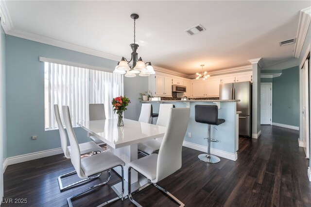 5779 Baffy Cir, Las Vegas, NV 89142 - dining area with a chandelier, dark wood finished floors, crown molding, and baseboards
