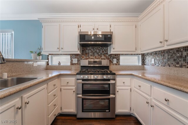 5779 Baffy Cir, Las Vegas, NV 89142 - kitchen with appliances with stainless steel finishes, a sink, tasteful backsplash, white cabinets, and crown molding