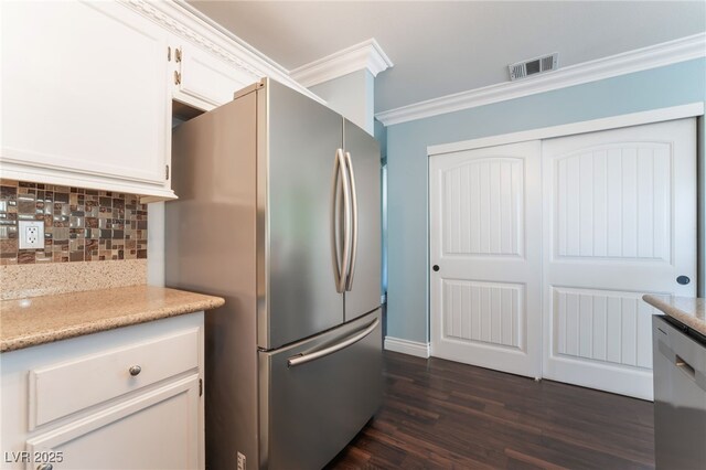 5779 Baffy Cir, Las Vegas, NV 89142 - kitchen with stainless steel appliances, ornamental molding, tasteful backsplash, dark wood-style flooring, and light countertops