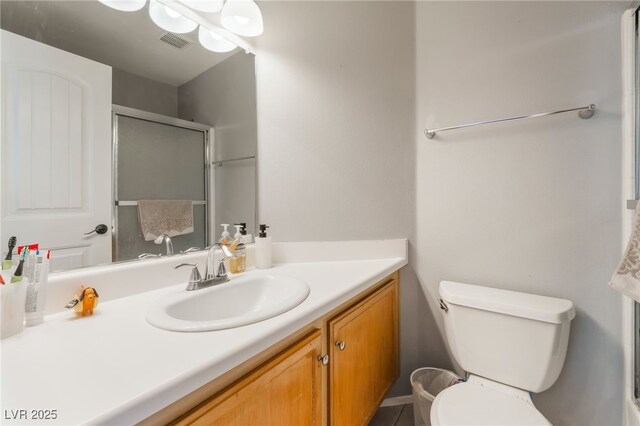 5779 Baffy Cir, Las Vegas, NV 89142 - bathroom featuring vanity, toilet, and an enclosed shower