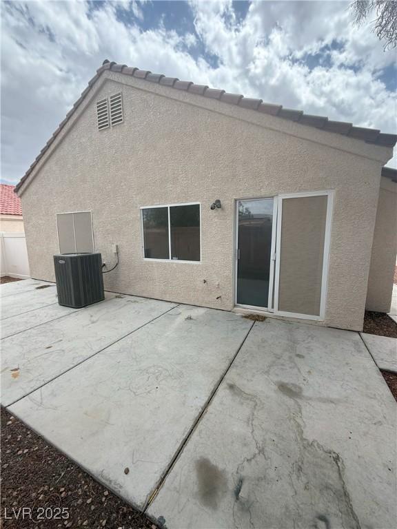 6642 Cinnabar Coast Ln, North Las Vegas, NV 89084 - back of property featuring stucco siding, a patio area, and central air condition unit