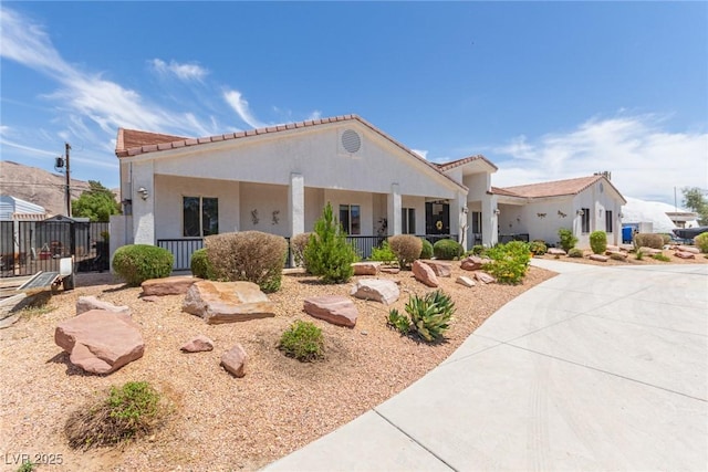 60 N Fogg St, Las Vegas, NV 89110 - view of front of house with a tile roof and stucco siding