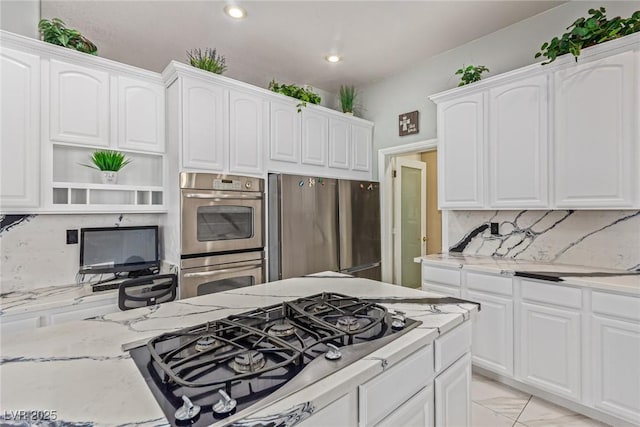 60 N Fogg St, Las Vegas, NV 89110 - kitchen with appliances with stainless steel finishes, light stone countertops, decorative backsplash, open shelves, and white cabinets