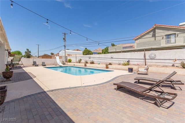 60 N Fogg St, Las Vegas, NV 89110 - view of pool with a water slide, a fenced backyard, and a patio
