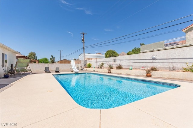 60 N Fogg St, Las Vegas, NV 89110 - view of swimming pool featuring a water slide, a fenced backyard, and a patio