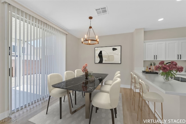 4132 Joyous St, North Las Vegas, NV 89032 - dining room with light wood-style flooring, baseboards, a chandelier, and recessed lighting