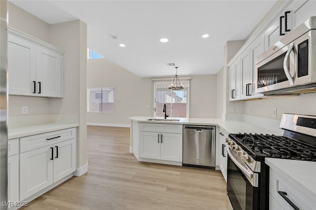 4132 Joyous St, North Las Vegas, NV 89032 - kitchen with appliances with stainless steel finishes, a sink, a chandelier, a peninsula, and recessed lighting