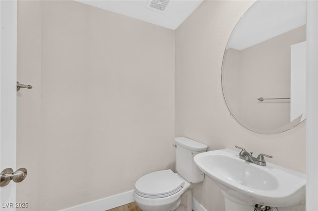 4132 Joyous St, North Las Vegas, NV 89032 - half bathroom with toilet, a sink, and baseboards