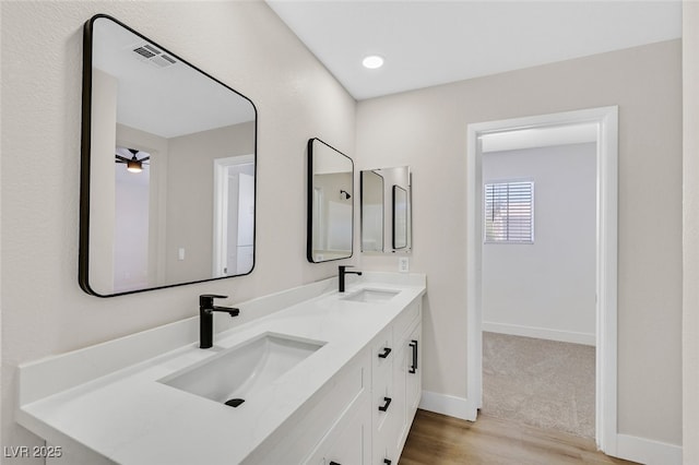 4132 Joyous St, North Las Vegas, NV 89032 - full bathroom with wood finished floors, double vanity, and baseboards