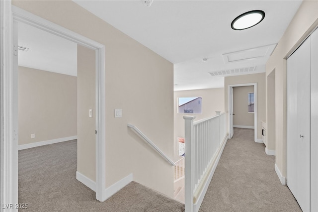 4132 Joyous St, North Las Vegas, NV 89032 - hallway with light carpet, an upstairs landing, attic access, and baseboards