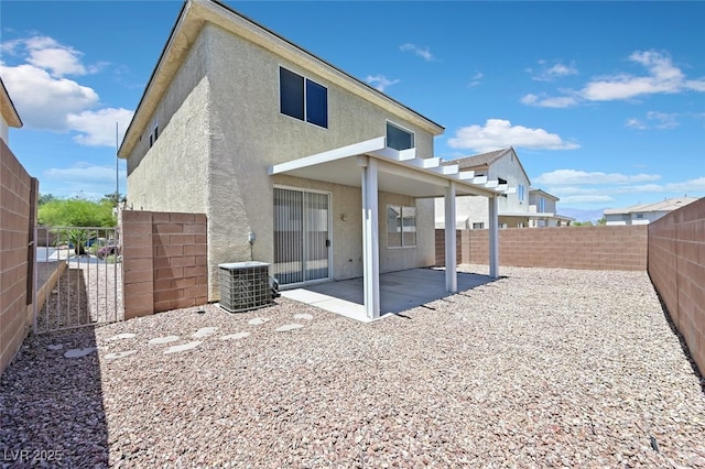 4132 Joyous St, North Las Vegas, NV 89032 - back of property featuring stucco siding, central AC unit, a patio area, and a fenced backyard