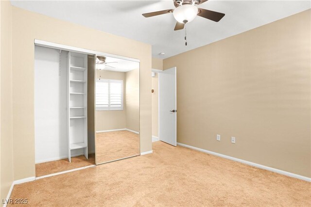 8928 Rusty Rifle Ave, Las Vegas, NV 89143 - unfurnished bedroom featuring light carpet, a closet, and a ceiling fan