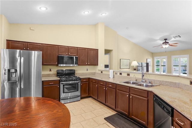 8928 Rusty Rifle Ave, Las Vegas, NV 89143 - kitchen with stainless steel appliances, lofted ceiling, light tile patterned flooring, ceiling fan, and light stone counters