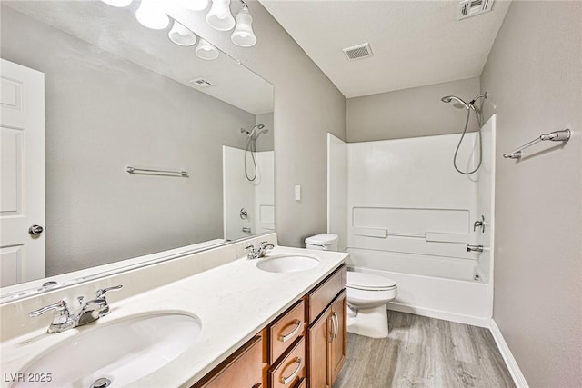 9271 Martel Ave, Las Vegas, NV 89148 - bathroom with toilet, wood finished floors, bathtub / shower combination, double vanity, and baseboards