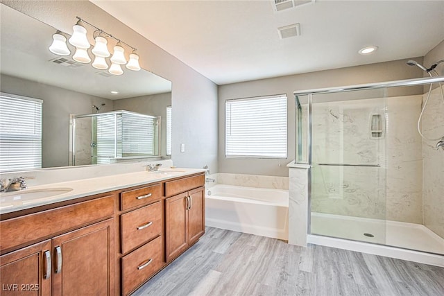 9271 Martel Ave, Las Vegas, NV 89148 - full bath featuring a stall shower, a bath, healthy amount of natural light, and wood finished floors