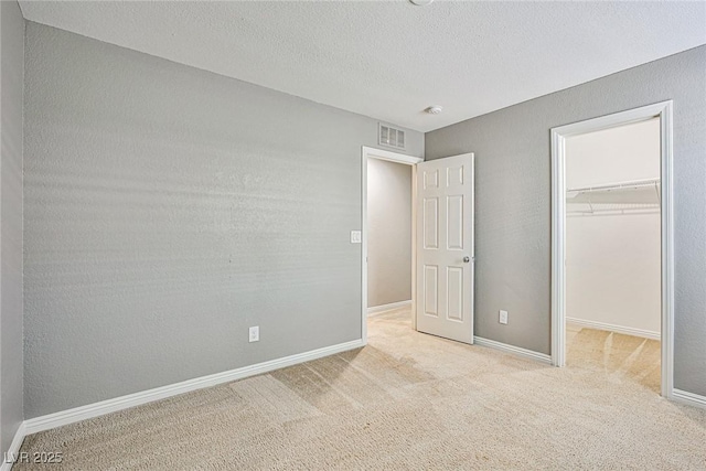 9271 Martel Ave, Las Vegas, NV 89148 - unfurnished bedroom featuring a spacious closet, carpet floors, a closet, a textured ceiling, and baseboards