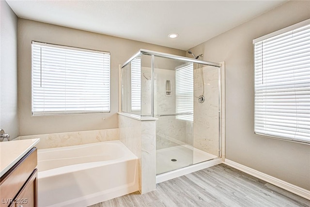 9271 Martel Ave, Las Vegas, NV 89148 - bathroom with a bath, a shower stall, wood finished floors, and vanity