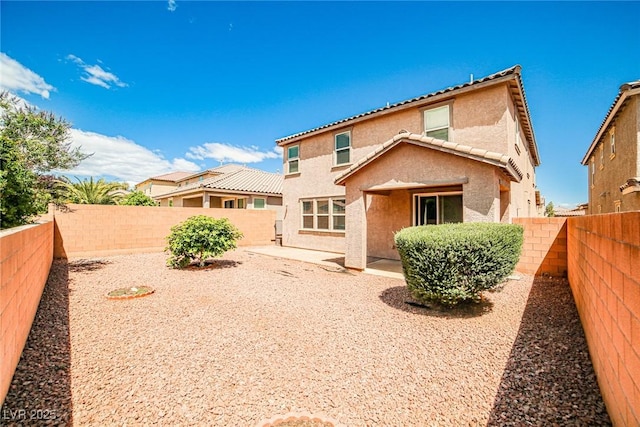 9271 Martel Ave, Las Vegas, NV 89148 - back of house featuring stucco siding, a fenced backyard, a tile roof, and a patio area