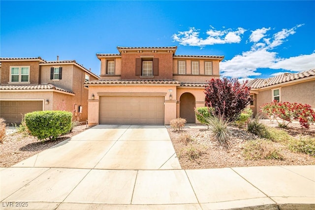 9271 Martel Ave, Las Vegas, NV 89148 - mediterranean / spanish house featuring a garage, concrete driveway, stucco siding, and a tile roof