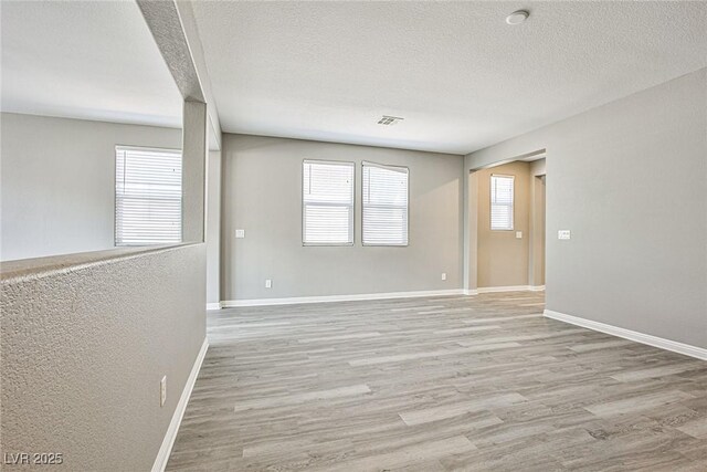 9271 Martel Ave, Las Vegas, NV 89148 - empty room with wood finished floors, a textured ceiling, and baseboards
